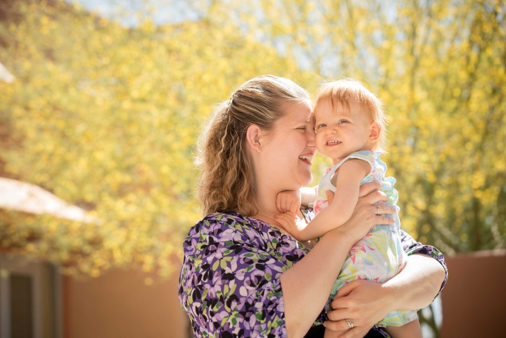 Mother Stacye holds and presses forehead with daughter Olivia B&W