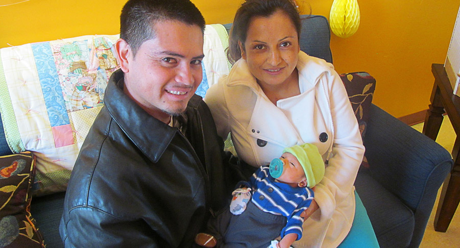 parents hold their small newborn