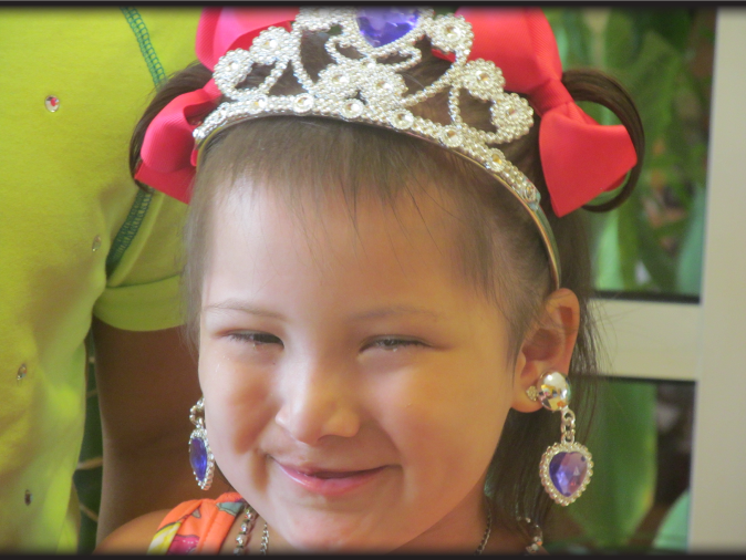 Krystal in her birthday crown smiling towards camera