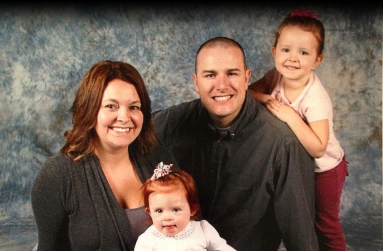 Payne Family infront of grey textured background posing for their family photo