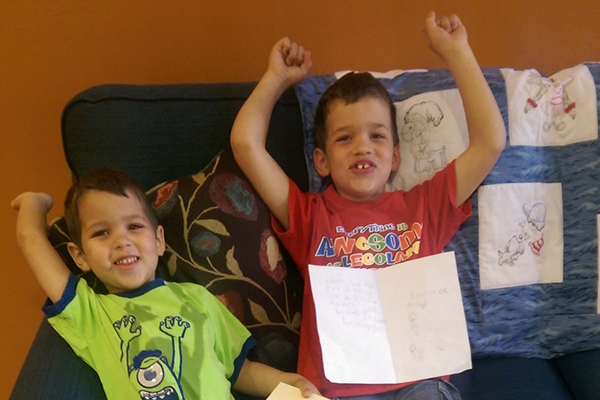 Zack and Jayden smile for the camera and raise their arms